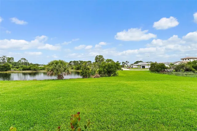 a view of a lake and houses in the back