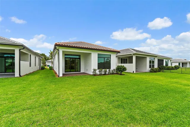 a view of a house with a backyard