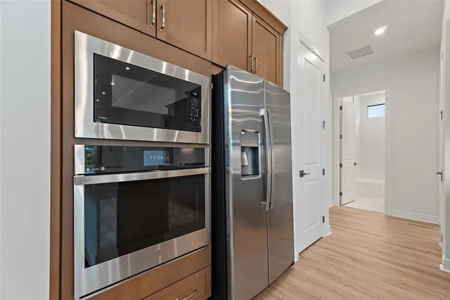 a kitchen with stainless steel appliances and cabinets