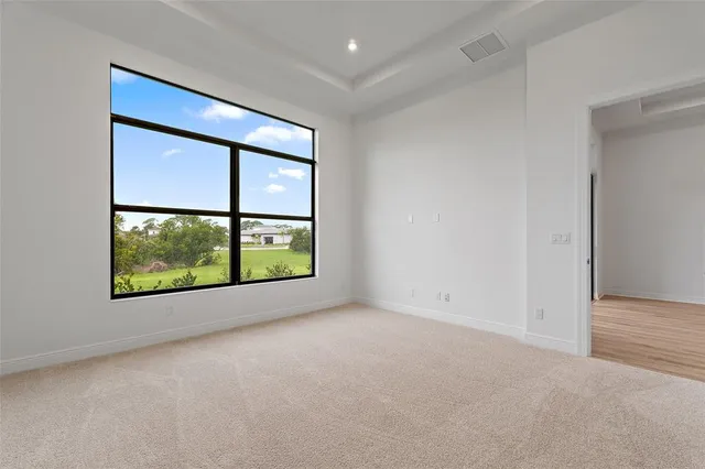 an empty room with large windows