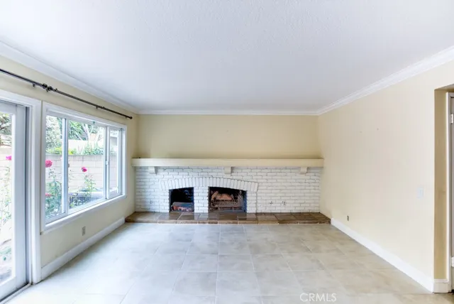 an empty room with furniture and a fireplace