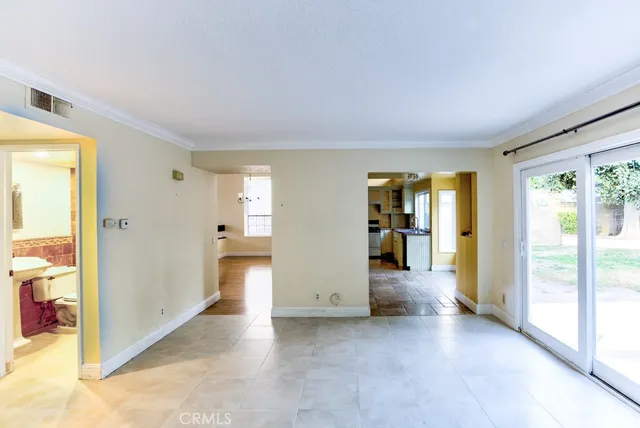 a view of a livingroom with wooden floor and windows