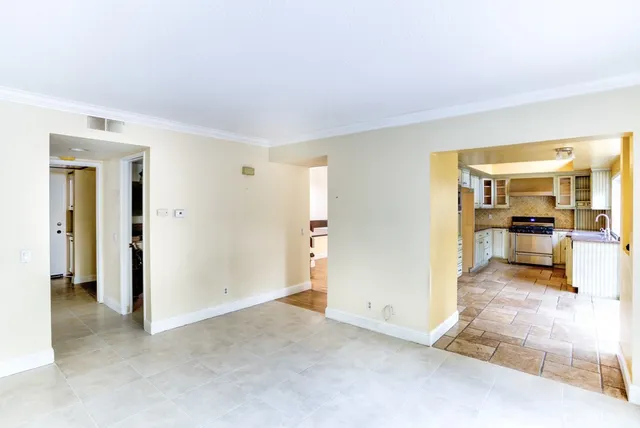 a view of a livingroom with furniture and a kitchen