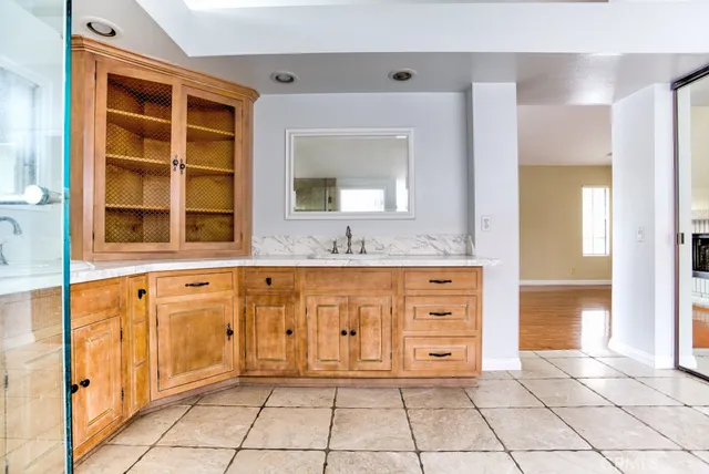 a bathroom with a tub sink vanity and mirror