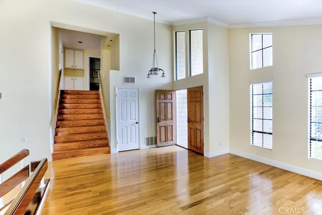 a view of a room with wooden floor and window