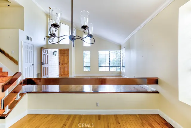 a living room with a couch and chandelier