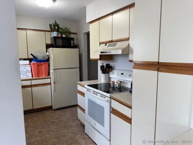 a kitchen with a refrigerator and a sink
