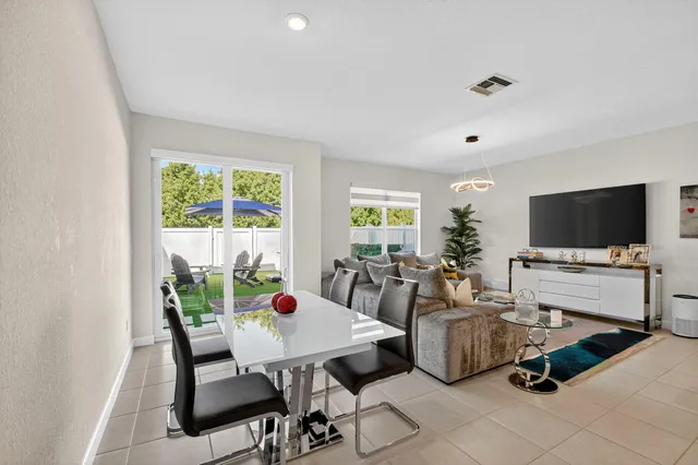a living room with furniture and kitchen view