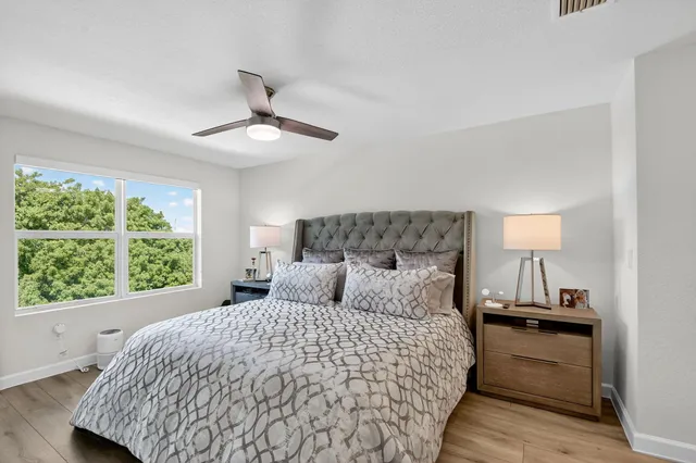 a bedroom with a bed and a flat tv screen on dresser