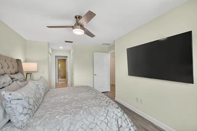 a bedroom with a large bed and a flat screen tv