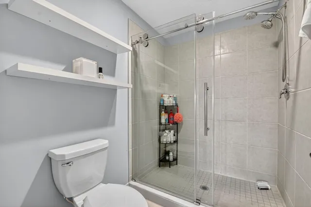 a living room with a flat screen tv and kitchen view