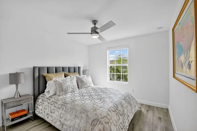 a bedroom with a bed and a painting on the wall