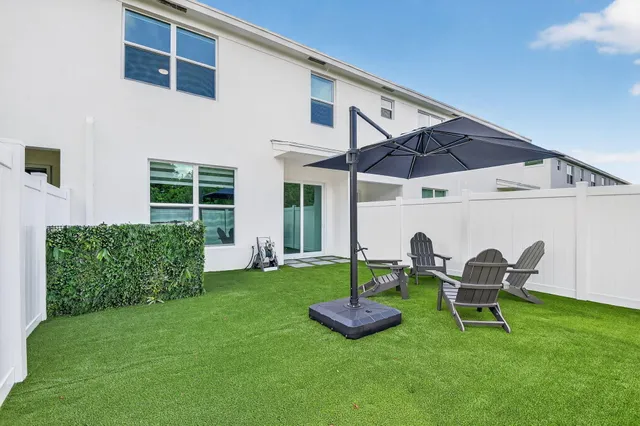 a lawn chairs sitting in a backyard