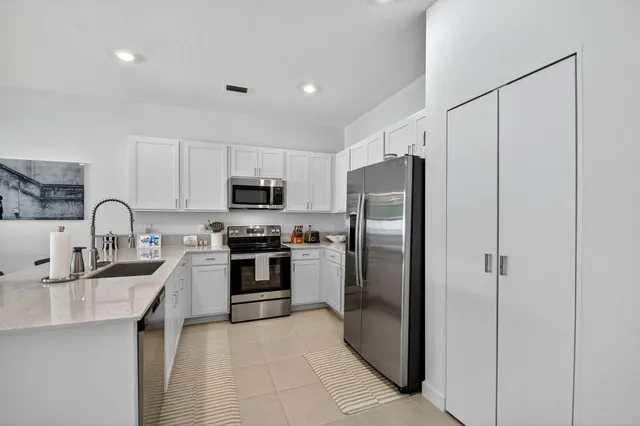 a kitchen with sink and cabinets