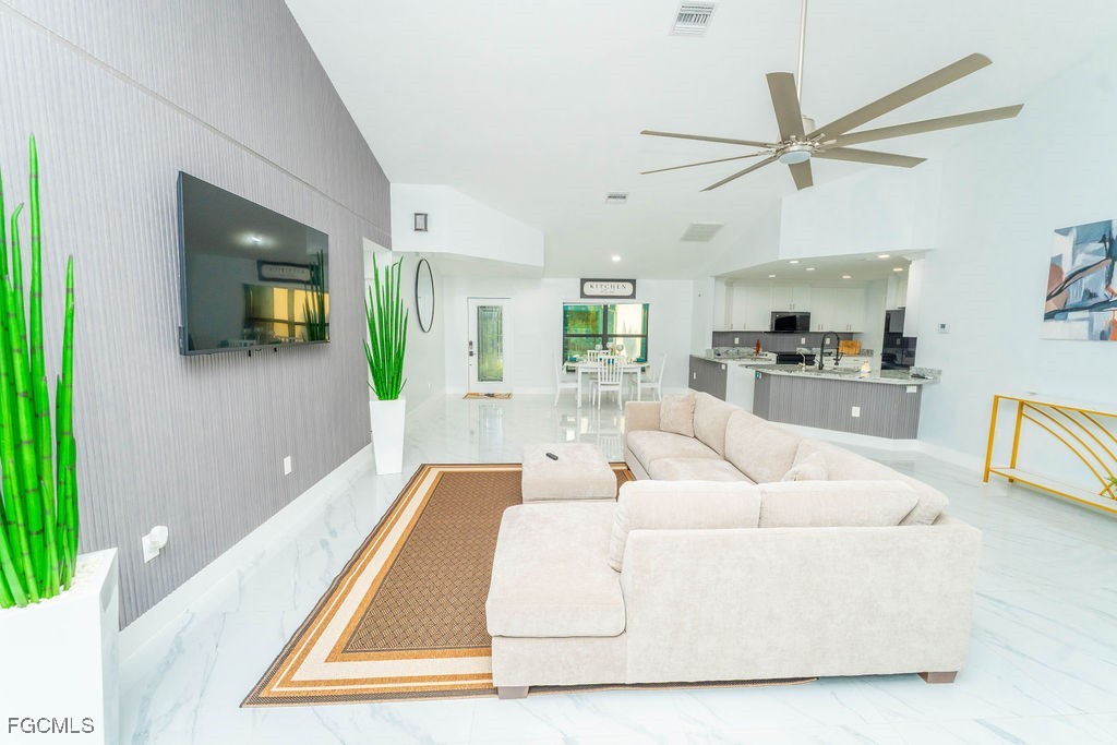 3613 39th Street Southwest Lehigh Acres, FL 33976 - Photo 11 of 46 a living room with furniture and a wooden floor