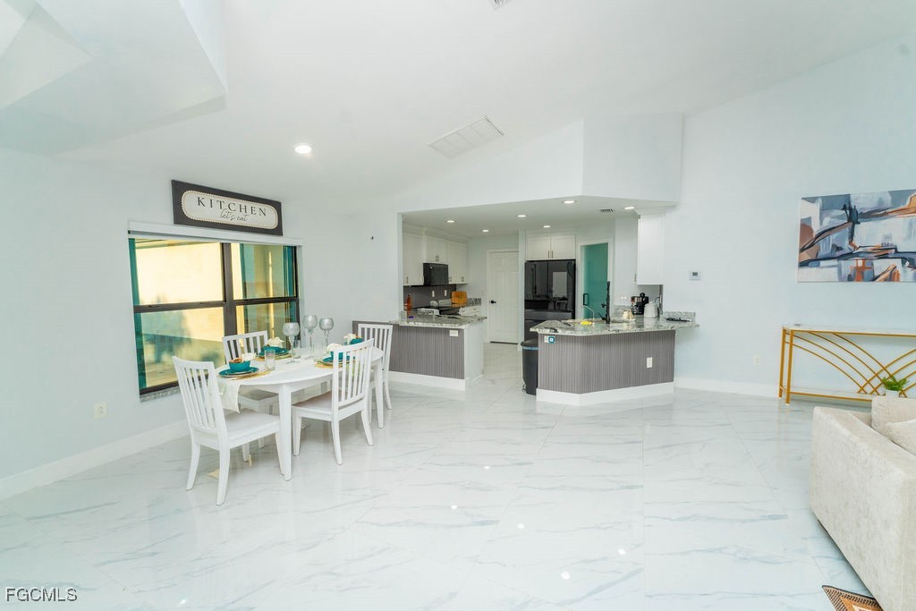 3613 39th Street Southwest Lehigh Acres, FL 33976 - Photo 17 of 46 a view of a dining room with furniture and a large window