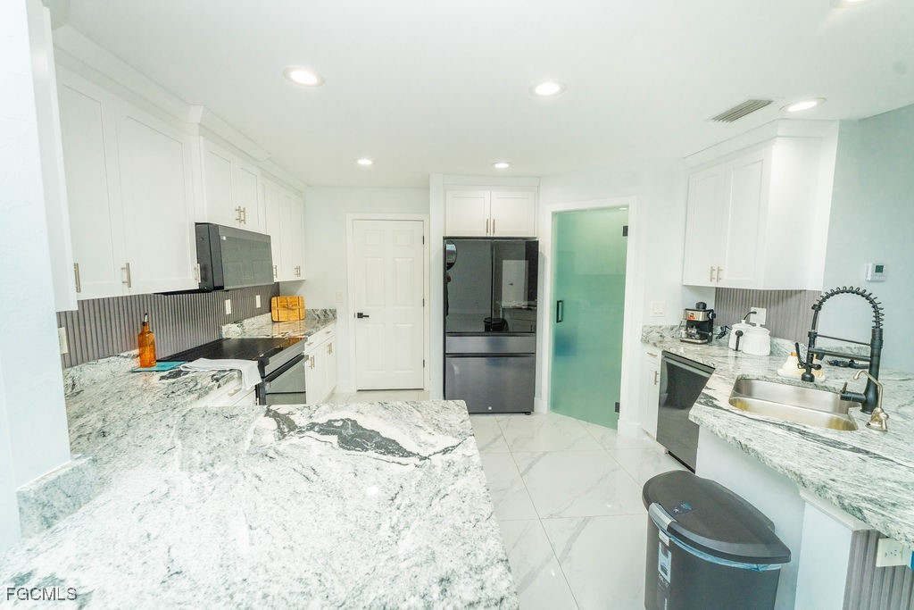 3613 39th Street Southwest Lehigh Acres, FL 33976 - Photo 20 of 46 a kitchen with a refrigerator sink and wooden floor