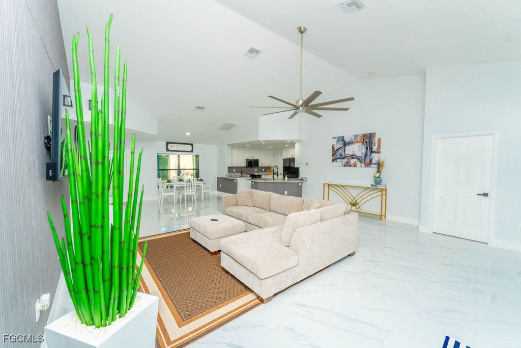 3613 39th Street Southwest Lehigh Acres, FL 33976 - Photo 2 of 46 a living room with a large window and a wooden floor