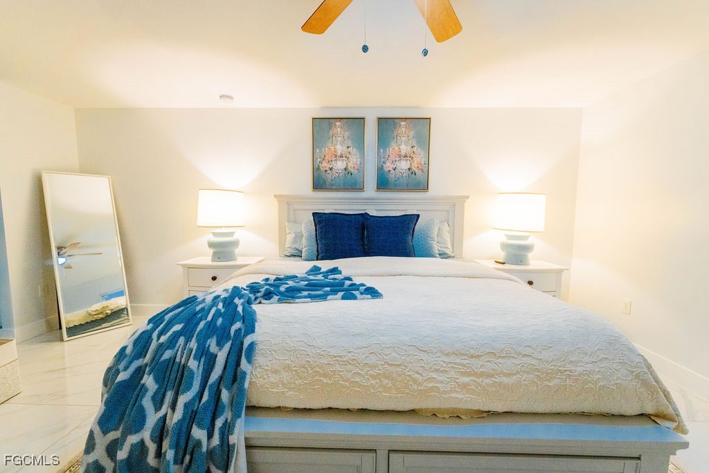 3613 39th Street Southwest Lehigh Acres, FL 33976 - Photo 21 of 46 a bedroom with a bed and a painting on the wall