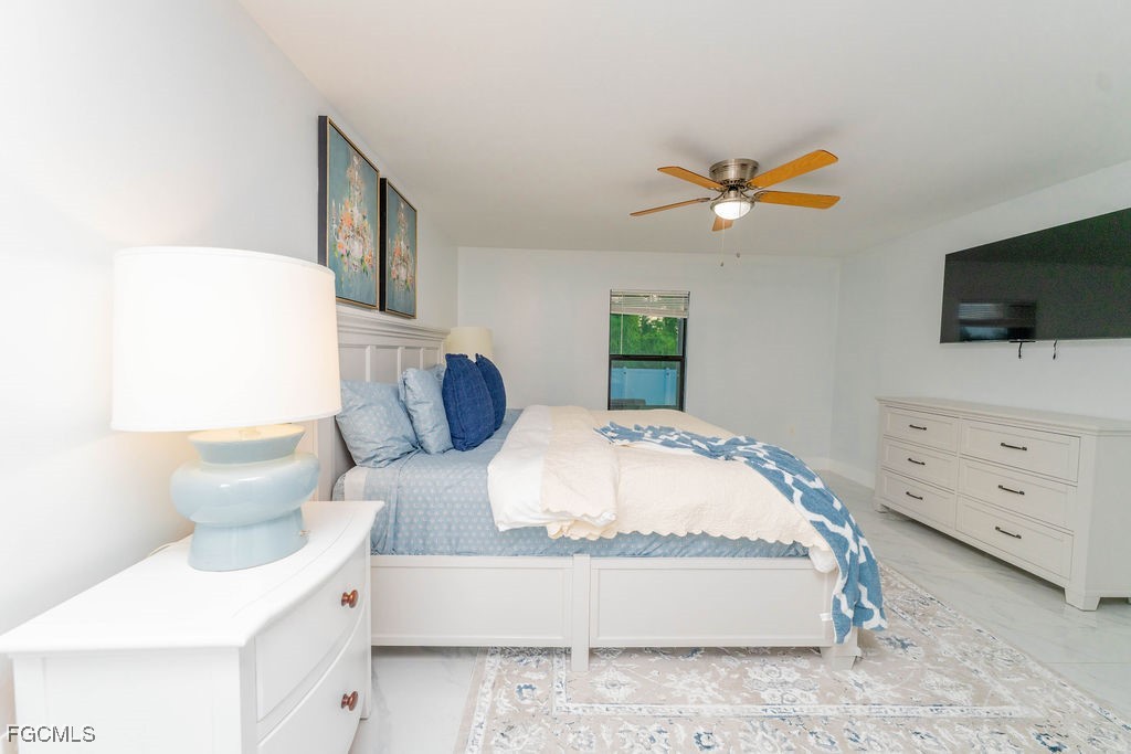 3613 39th Street Southwest Lehigh Acres, FL 33976 - Photo 24 of 46 a bedroom with a bed and a flat screen tv