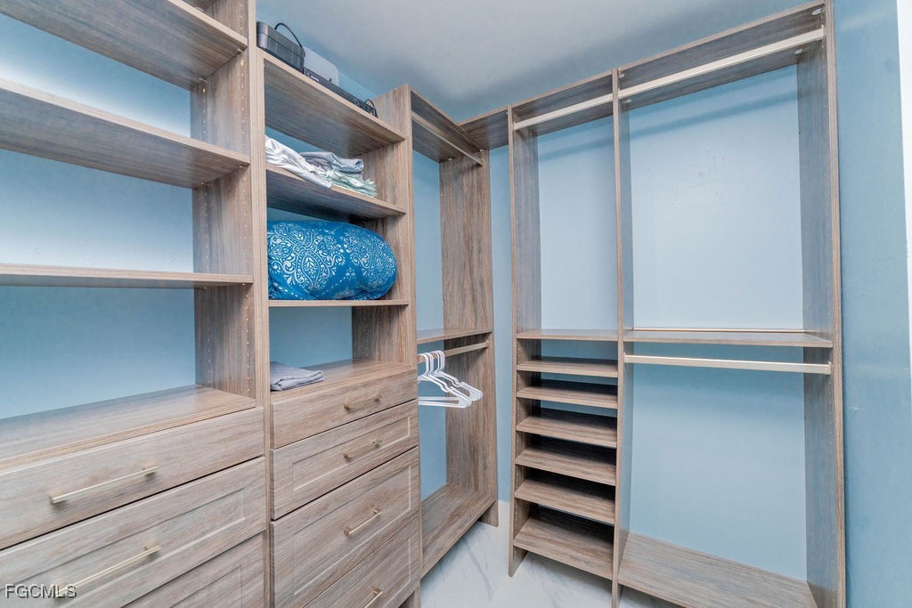 3613 39th Street Southwest Lehigh Acres, FL 33976 - Photo 27 of 46 a view of walk in closet with empty racks