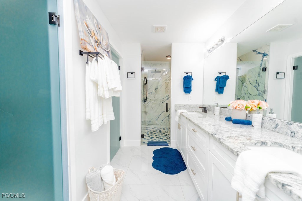 3613 39th Street Southwest Lehigh Acres, FL 33976 - Photo 28 of 46 a large bathroom with a granite countertop sink a toilet and shower