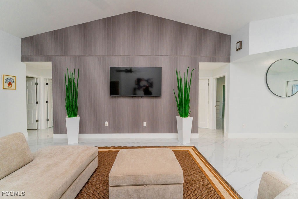 3613 39th Street Southwest Lehigh Acres, FL 33976 - Photo 3 of 46 a living room with furniture and a flat screen tv