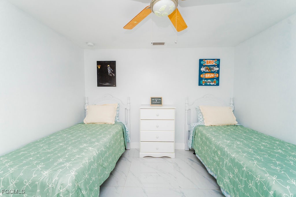 3613 39th Street Southwest Lehigh Acres, FL 33976 - Photo 35 of 46 a bedroom with a bed and a window