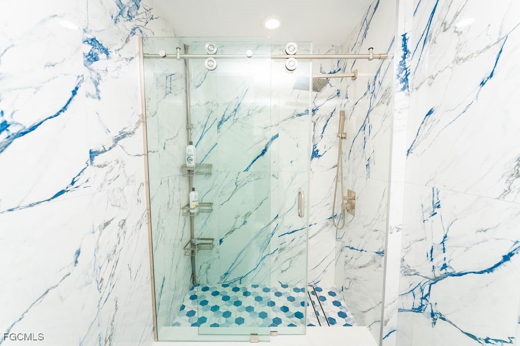 3613 39th Street Southwest Lehigh Acres, FL 33976 - Photo 37 of 46 a bathroom with a shower curtain and a window