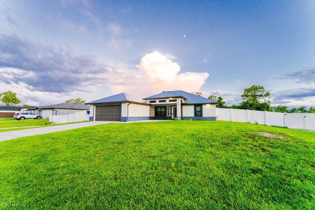 3613 39th Street Southwest Lehigh Acres, FL 33976 - Photo 42 of 46 a view of a house with a big yard potted plants and a large tree