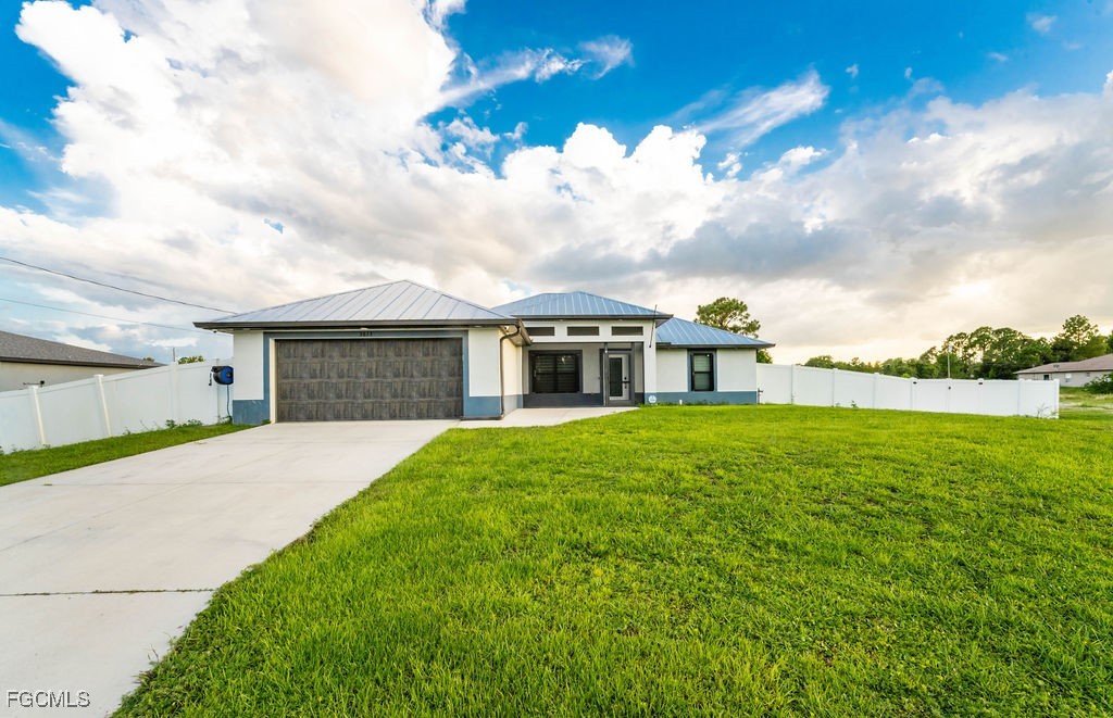 3613 39th Street Southwest Lehigh Acres, FL 33976 - Photo 44 of 46 a front view of a house with garden