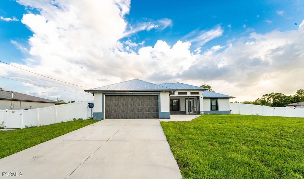 3613 39th Street Southwest Lehigh Acres, FL 33976 - Photo 45 of 46 front view of a house with a yard