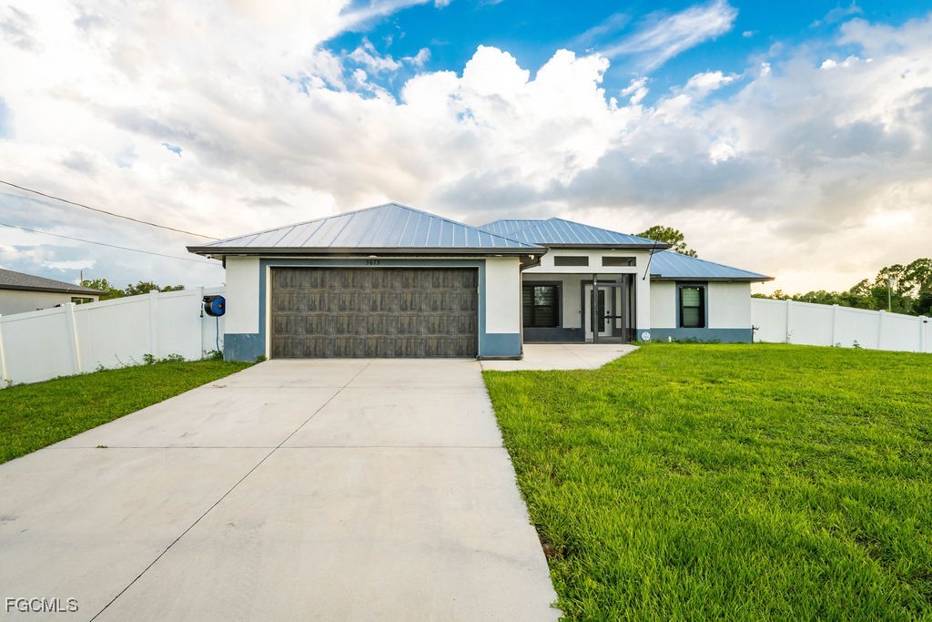 3613 39th Street Southwest Lehigh Acres, FL 33976 - Photo 46 of 46 a front view of a house with a garden