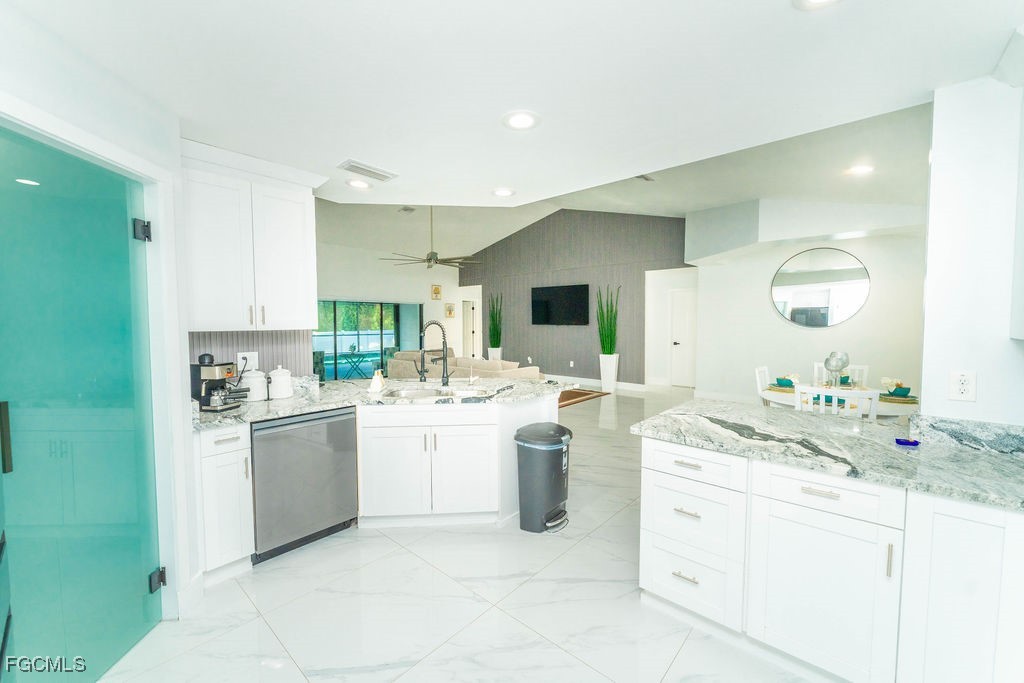 3613 39th Street Southwest Lehigh Acres, FL 33976 - Photo 5 of 46 a kitchen with a sink stove and cabinets