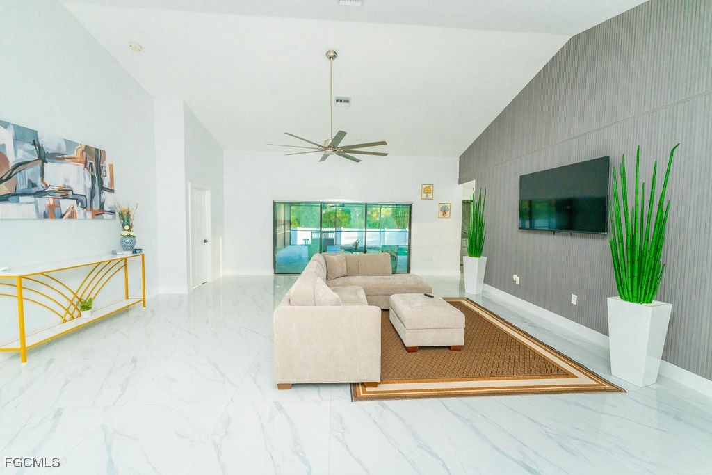 3613 39th Street Southwest Lehigh Acres, FL 33976 - Photo 8 of 46 a living room with a bed furniture and a flat screen tv