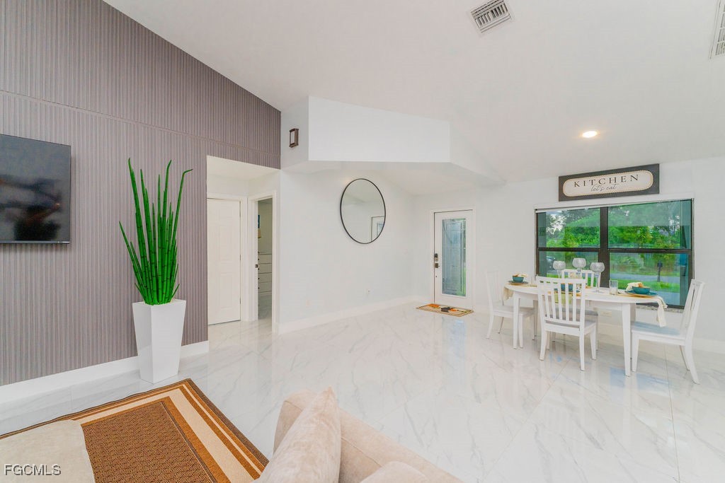 3613 39th Street Southwest Lehigh Acres, FL 33976 - Photo 9 of 46 a living room with furniture a table and a large window