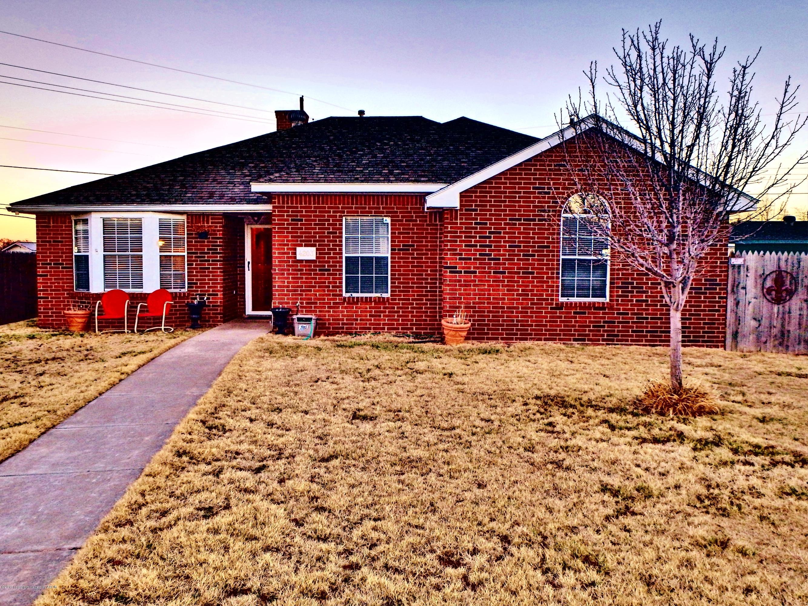 4203 Rincon Avenue Amarillo, TX 79110 - Photo 1 of 39 a front view of a house with a yard