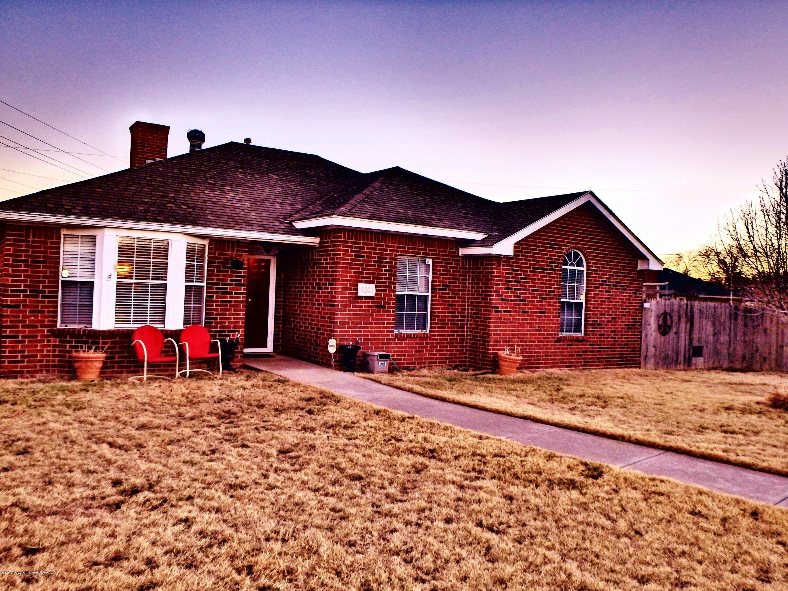 4203 Rincon Avenue Amarillo, TX 79110 - Photo 2 of 39 a view of a house with a yard and wooden fence