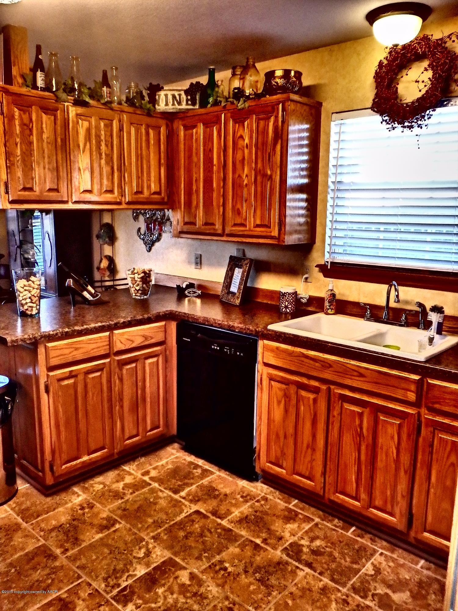 4203 Rincon Avenue Amarillo, TX 79110 - Photo 11 of 39 a kitchen with stainless steel appliances granite countertop a sink stove and cabinets