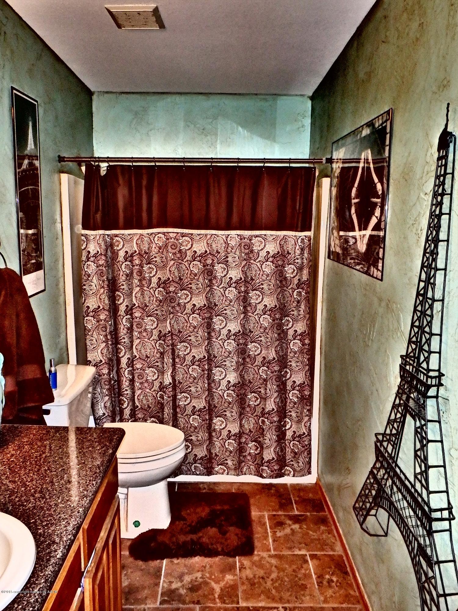 4203 Rincon Avenue Amarillo, TX 79110 - Photo 14 of 39 a bathroom with a sink toilet and shower