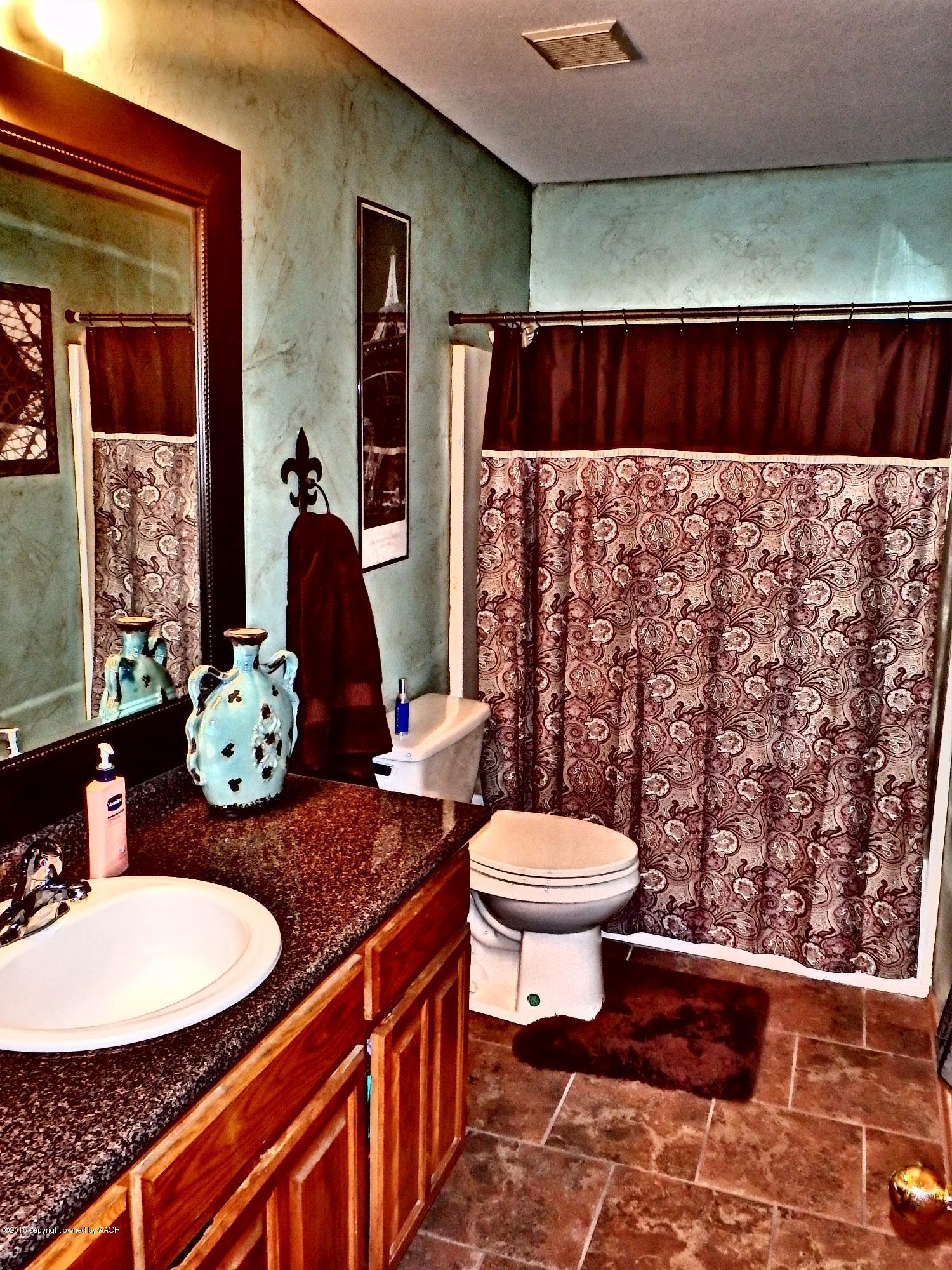 4203 Rincon Avenue Amarillo, TX 79110 - Photo 15 of 39 a bathroom with a sink and a mirror
