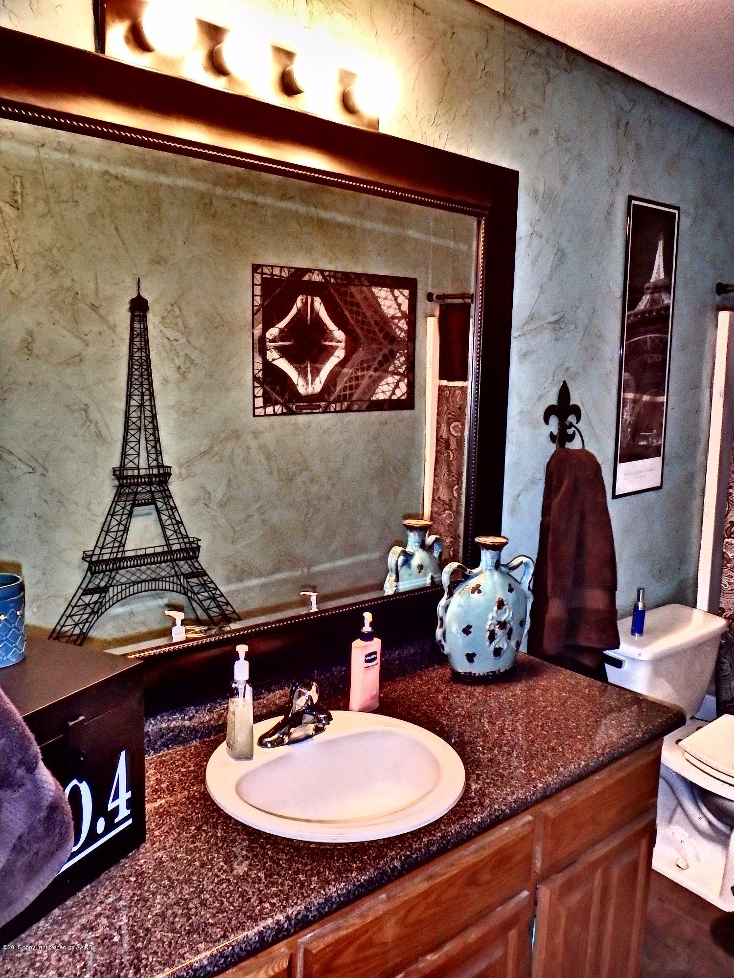 4203 Rincon Avenue Amarillo, TX 79110 - Photo 16 of 39 a bathroom with a sink and a mirror