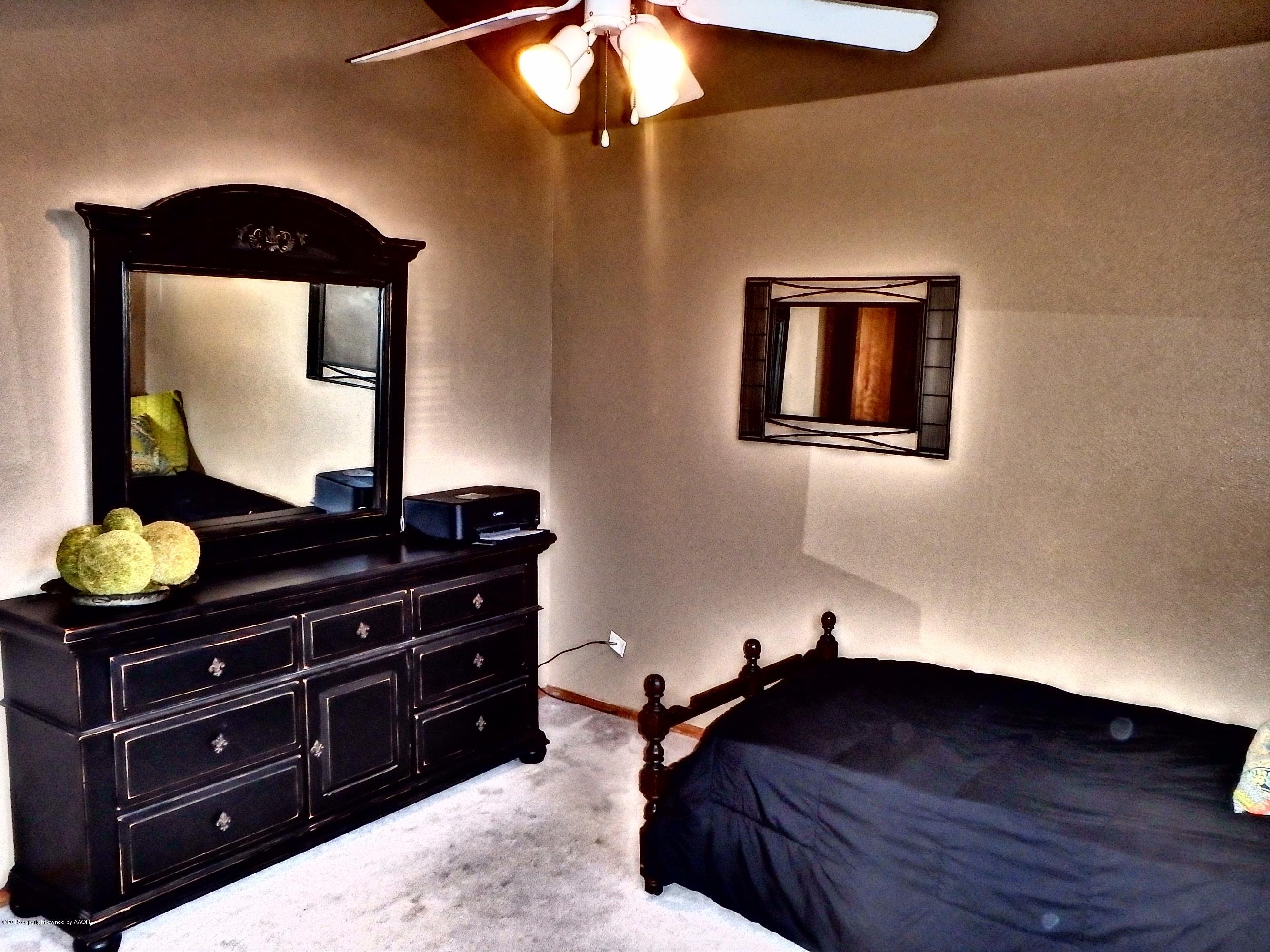 4203 Rincon Avenue Amarillo, TX 79110 - Photo 17 of 39 a room with a bed and a dresser