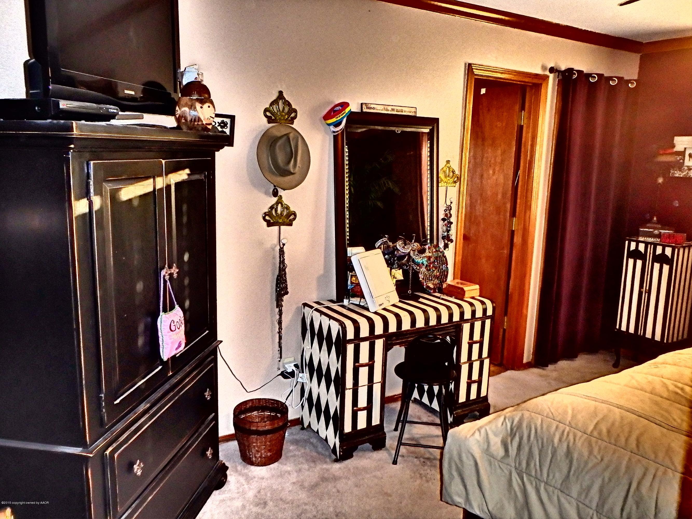 4203 Rincon Avenue Amarillo, TX 79110 - Photo 22 of 39 a bedroom with furniture and workout equipment
