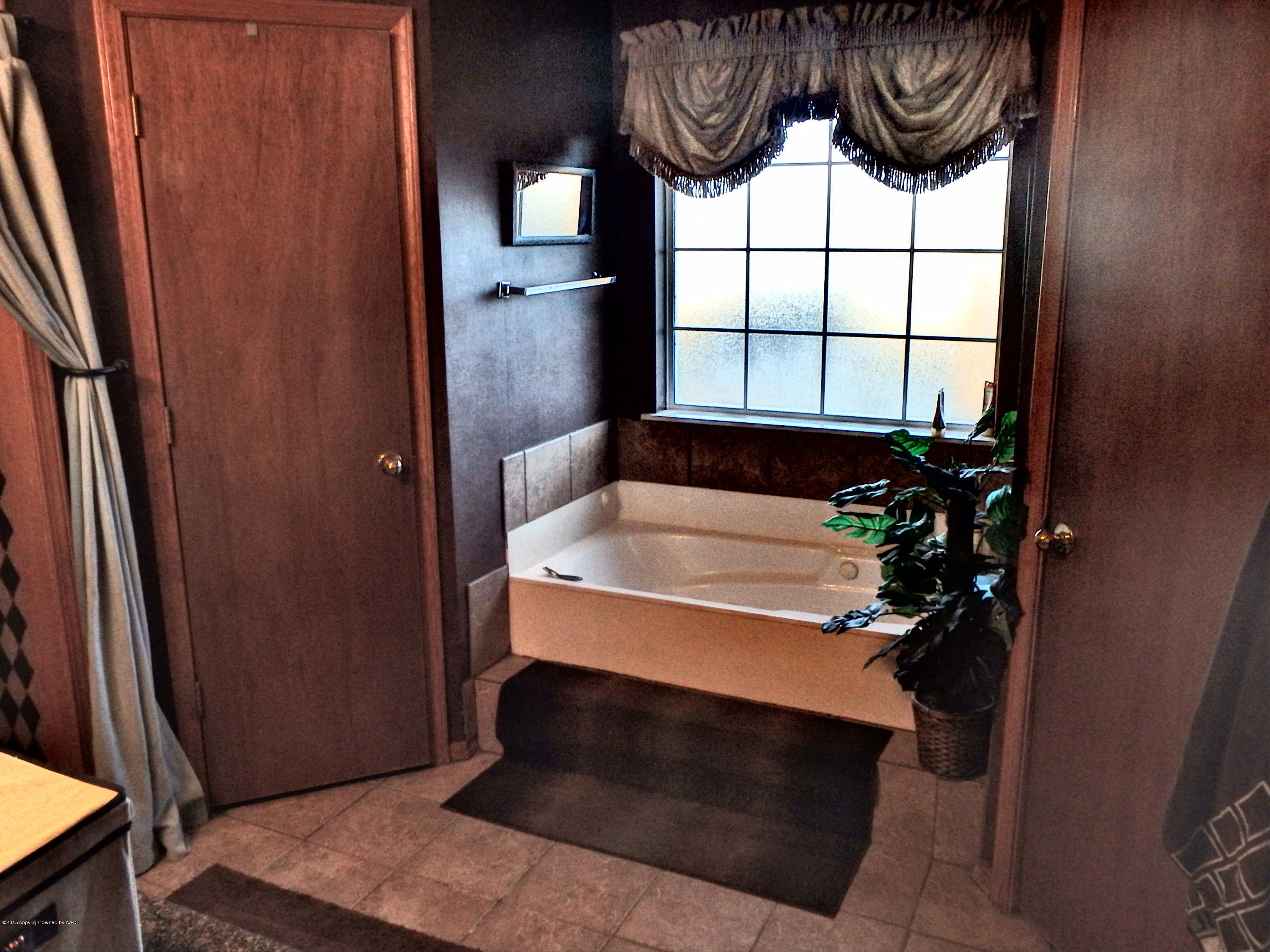 4203 Rincon Avenue Amarillo, TX 79110 - Photo 26 of 39 a bathroom with a sink and a mirror