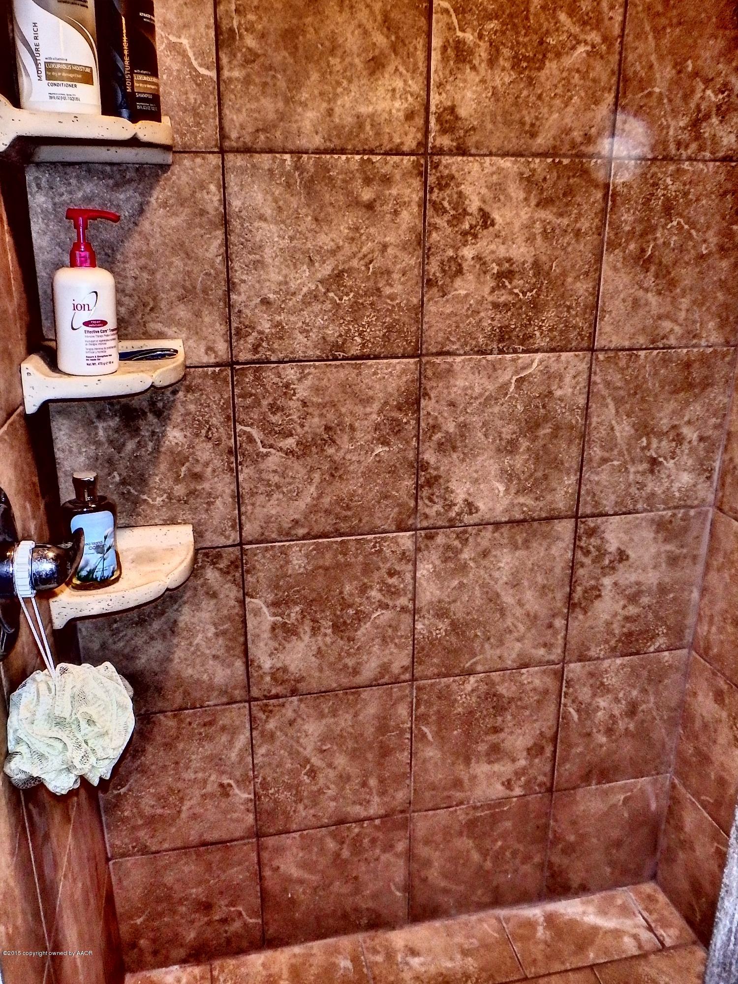 4203 Rincon Avenue Amarillo, TX 79110 - Photo 29 of 39 a bathroom with a shower