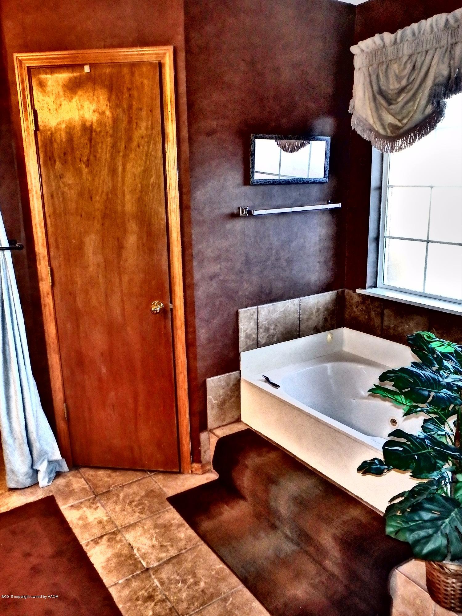 4203 Rincon Avenue Amarillo, TX 79110 - Photo 30 of 39 a bathroom with a bathtub and shower