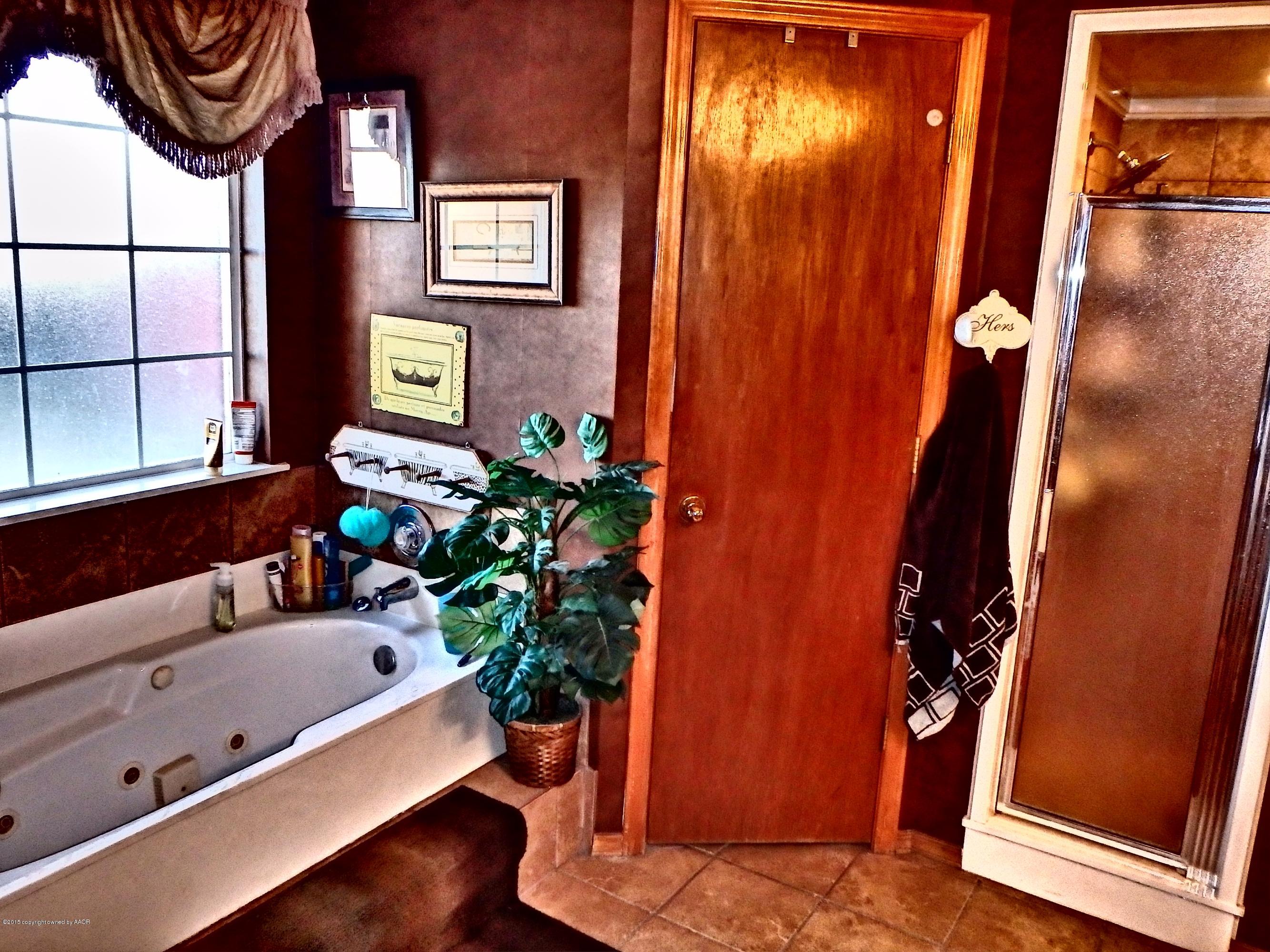 4203 Rincon Avenue Amarillo, TX 79110 - Photo 31 of 39 a bath room with a sink and a mirror