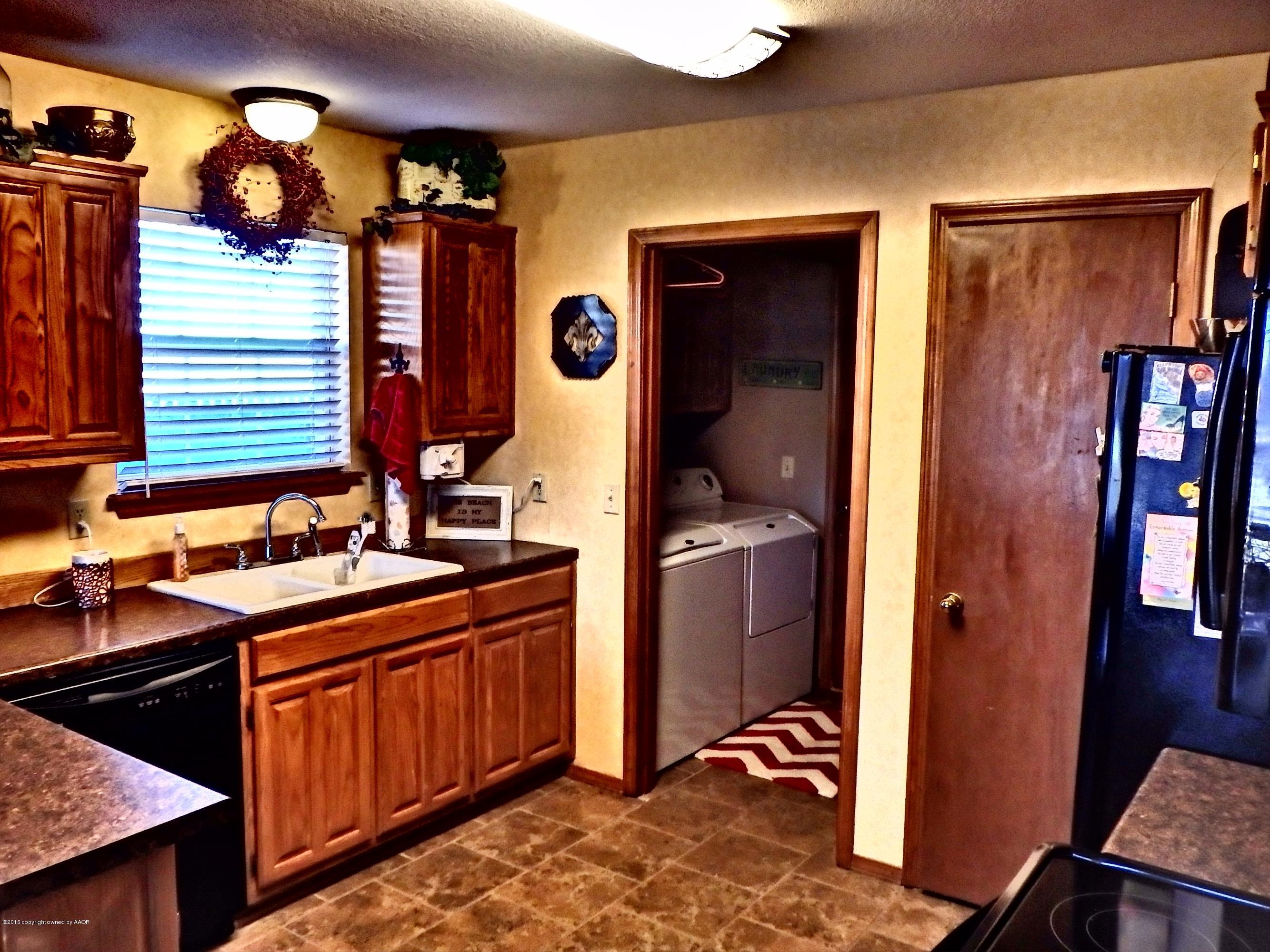 4203 Rincon Avenue Amarillo, TX 79110 - Photo 10 of 39 a kitchen with a sink stove and refrigerator