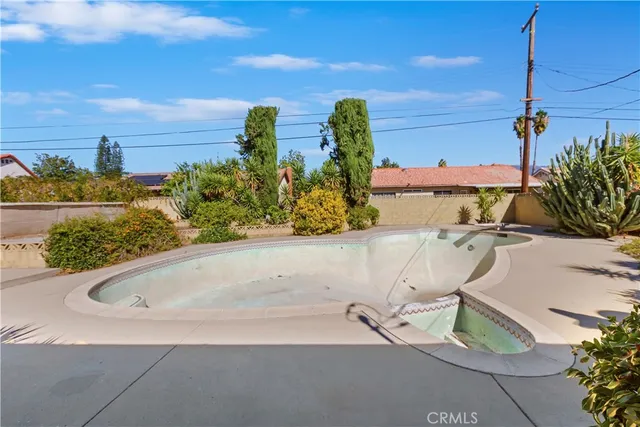 a view of a backyard with plants and a patio